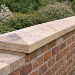 Ancaster Base Bed twice weathered coping stones installed on a boundary wall with dual slope for water runoff