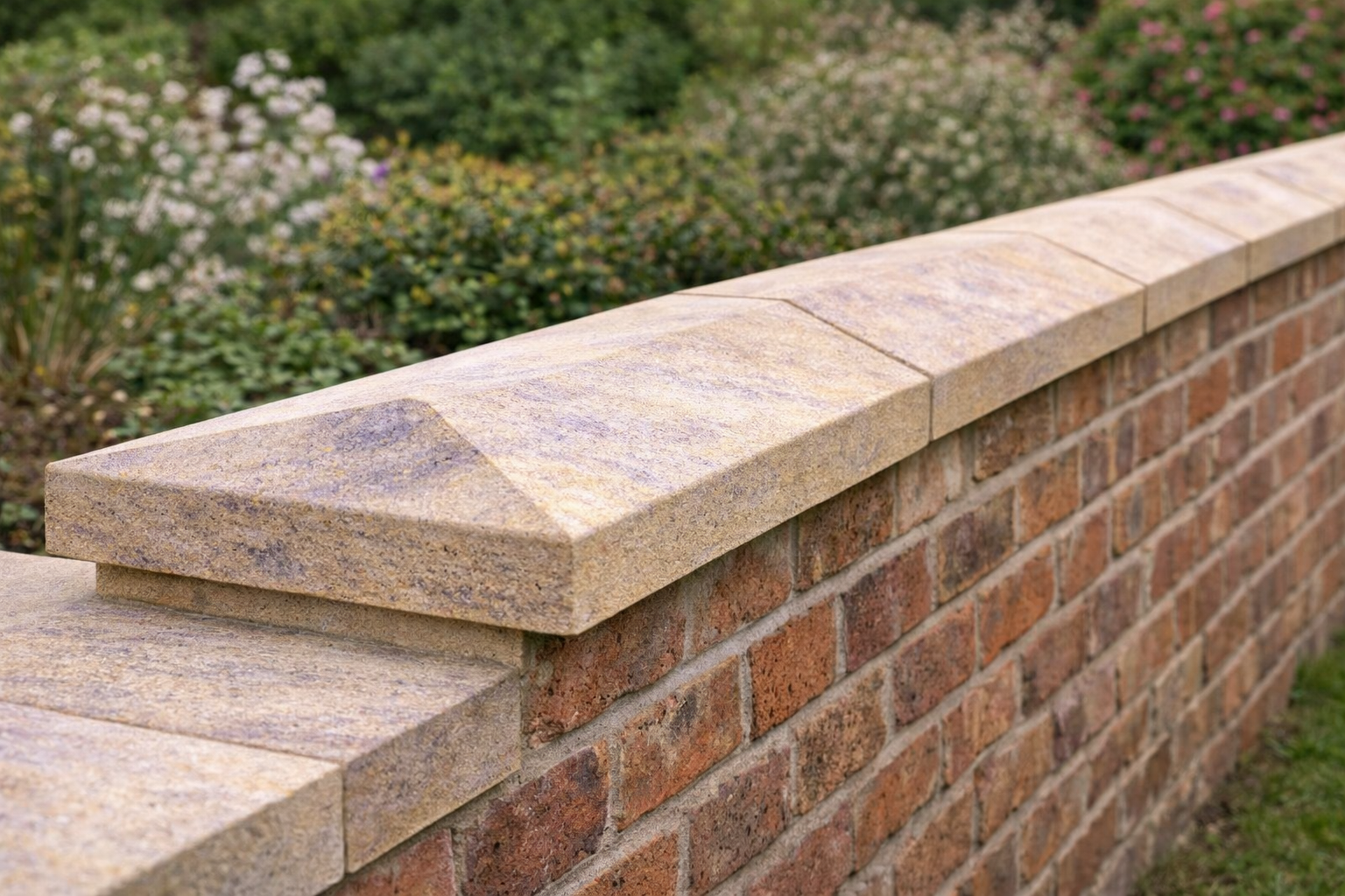 Ancaster Base Bed twice weathered coping stones installed on a boundary wall with dual slope for water runoff