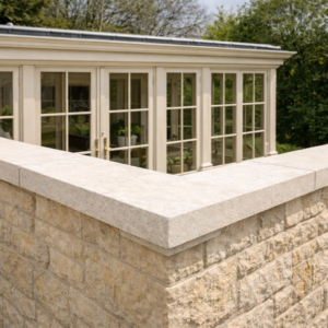 Bathstone flat coping stones on a brick orangery wall with smooth light stone finish and square edges.