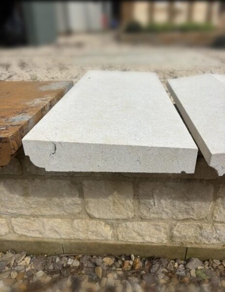 Once weathered Bathstone coping with cavetto detail, finished in a clean off-white tone