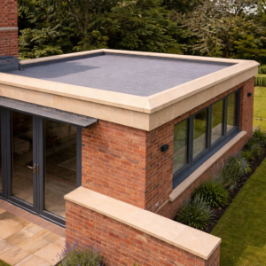 Scotch buff chamfered edge coping stones on a brick parapet wall with a clean bevelled edge finish